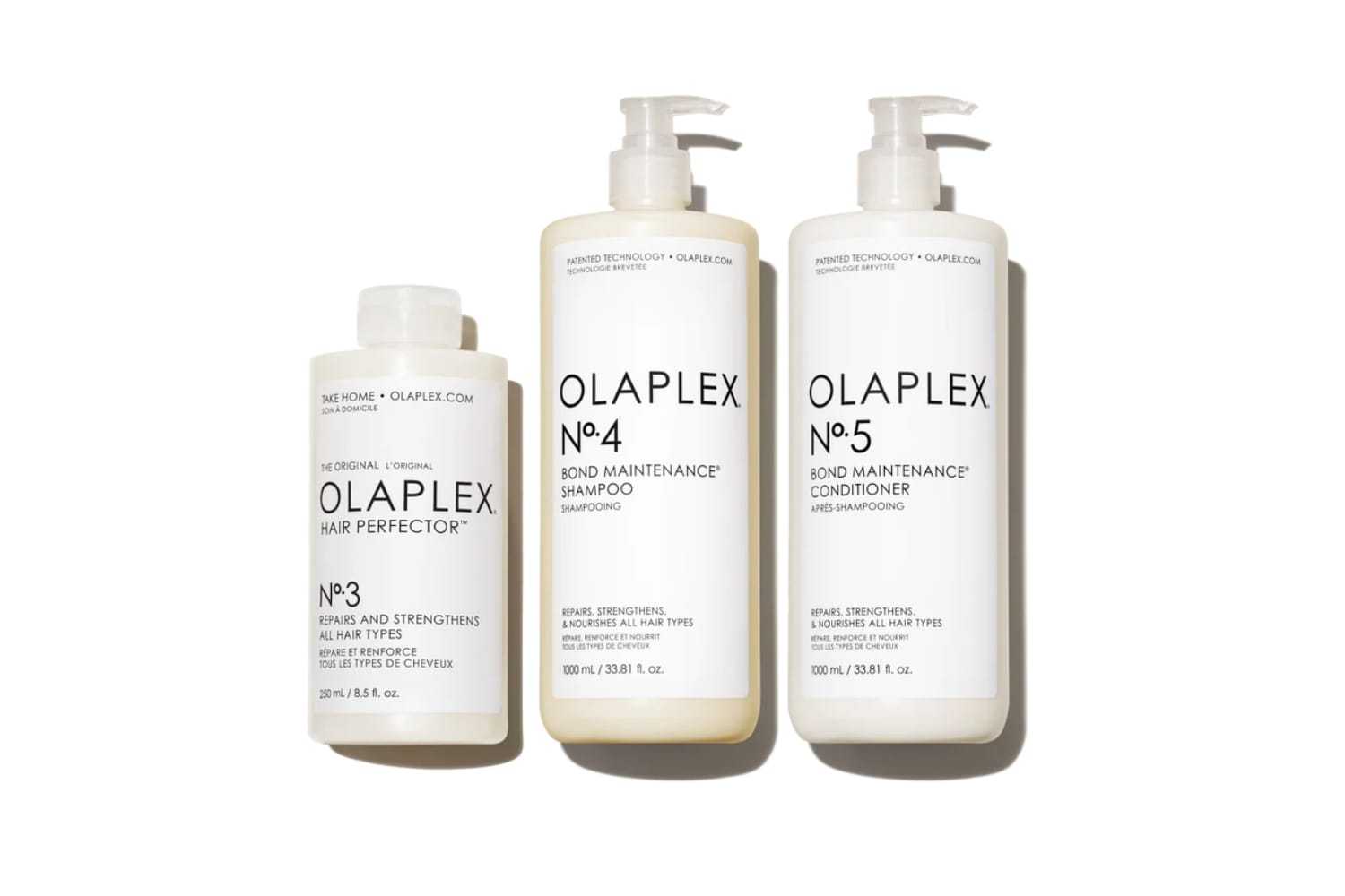 Olaplex hair products: No. 3 Hair Perfector, No. 4 Shampoo, No. 5 Conditioner in bottles.