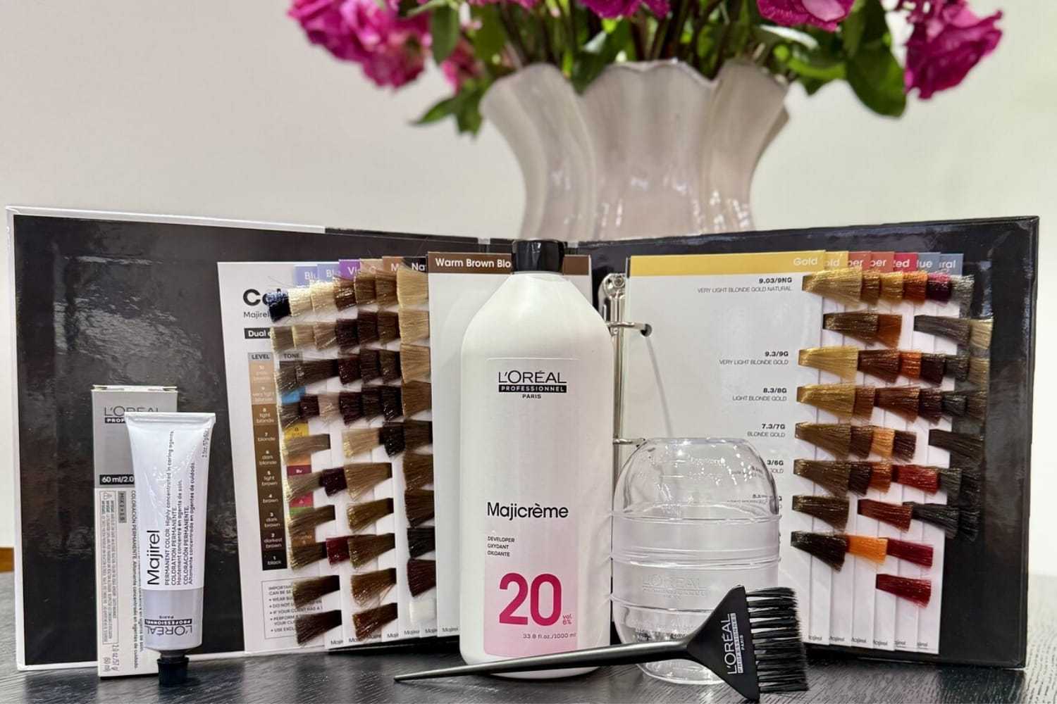 Hair color kit with Majicrème 20, brushes, and color samples on display.