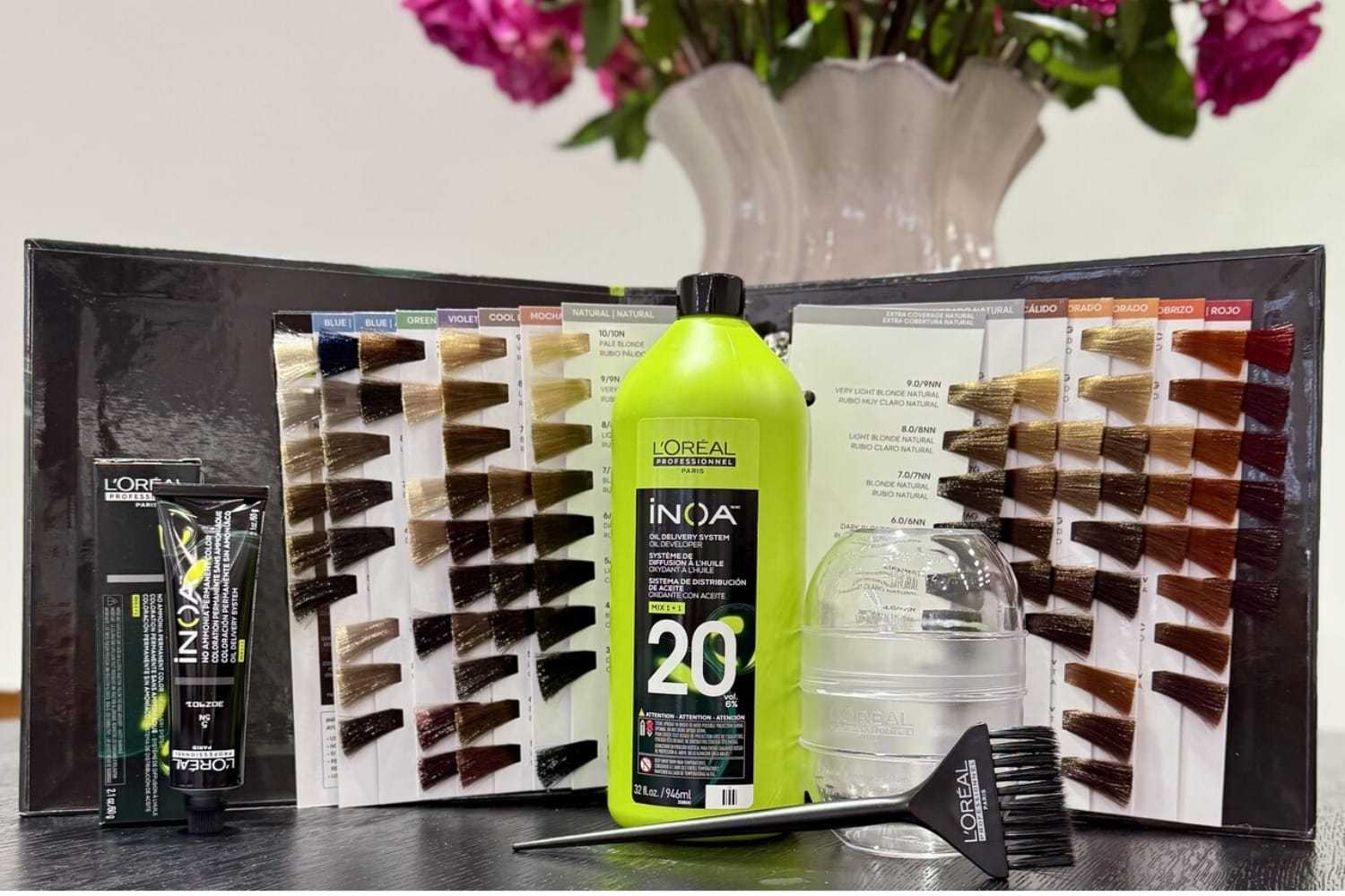 L'Oréal hair color products with shade chart, dye tube, peroxide bottle, and mixing tools.