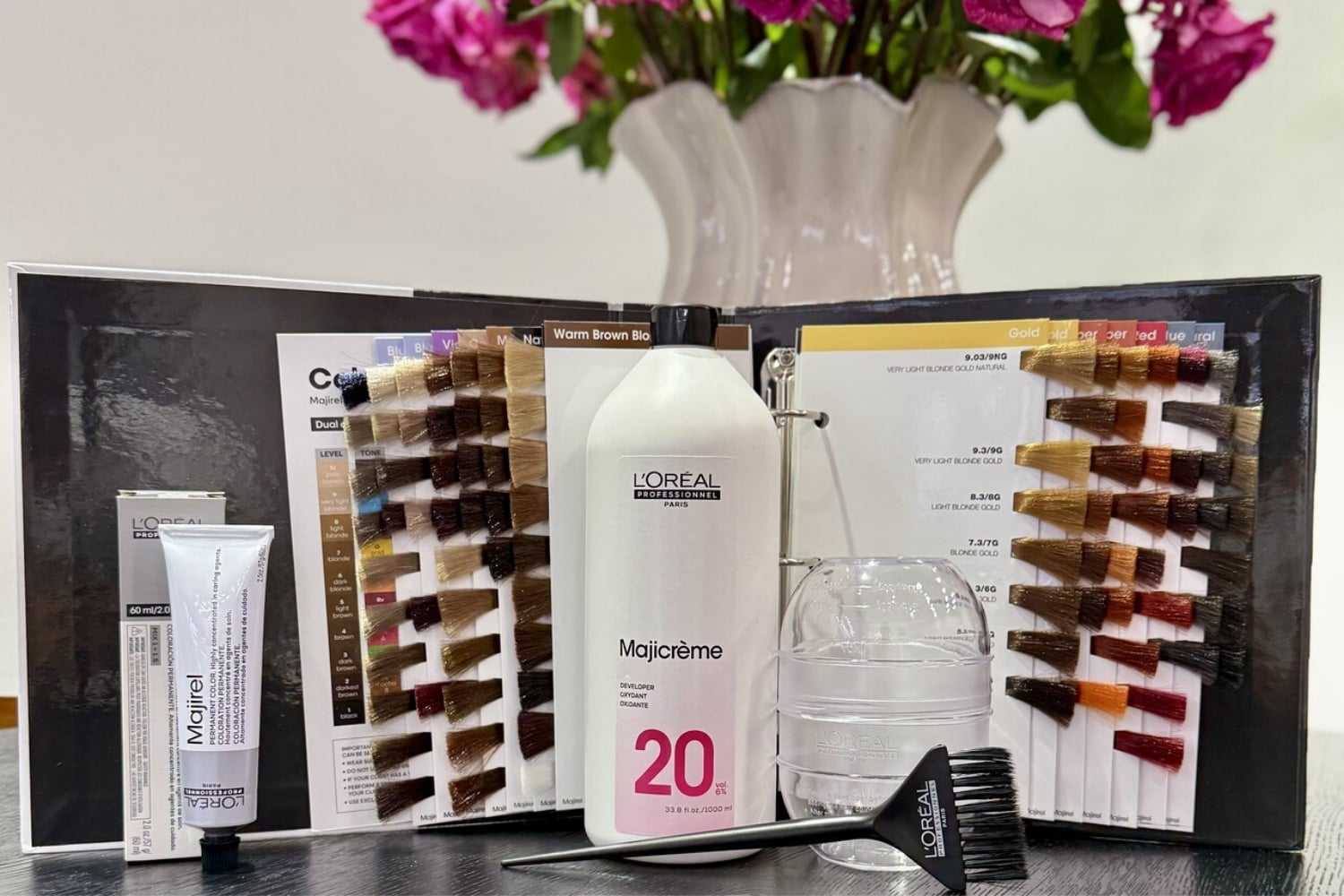 Hair color kit with Majicrème 20, brushes, and color samples on display.