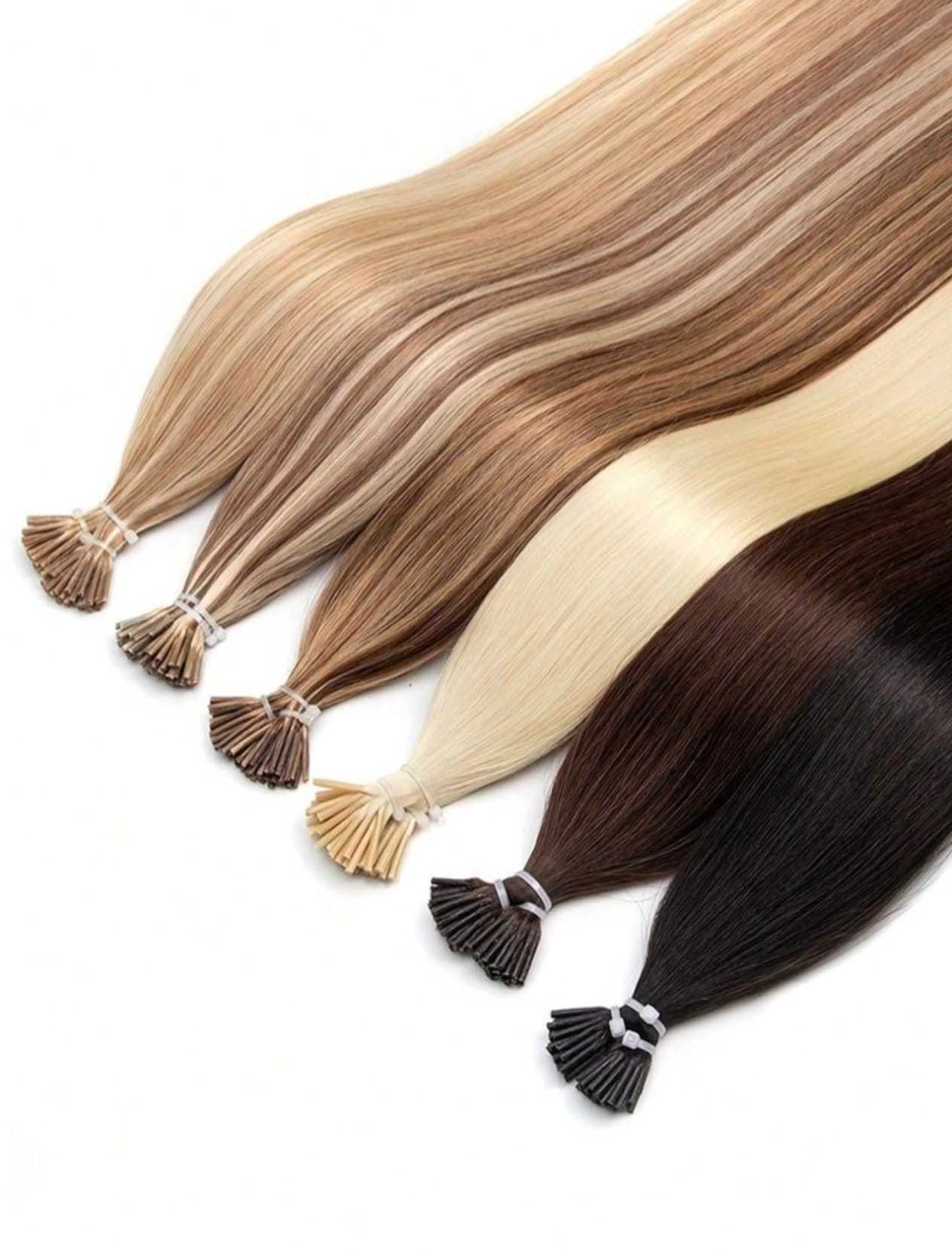 Hair extensions in various shades from blonde to brunette, neatly arranged on a white surface.
