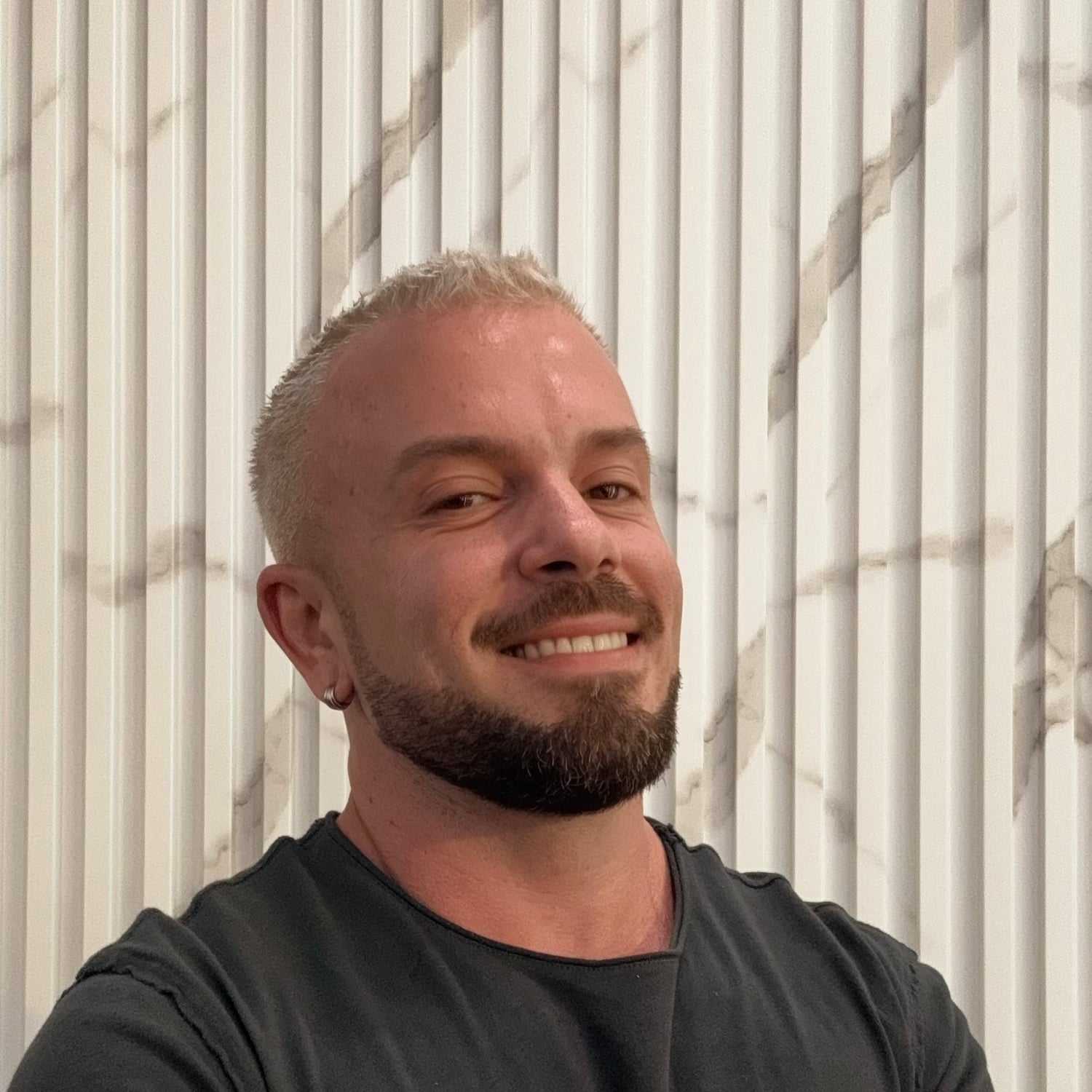 Portrait of Eddy, a professional stylist at A&D Salon, showcasing their expertise and style.